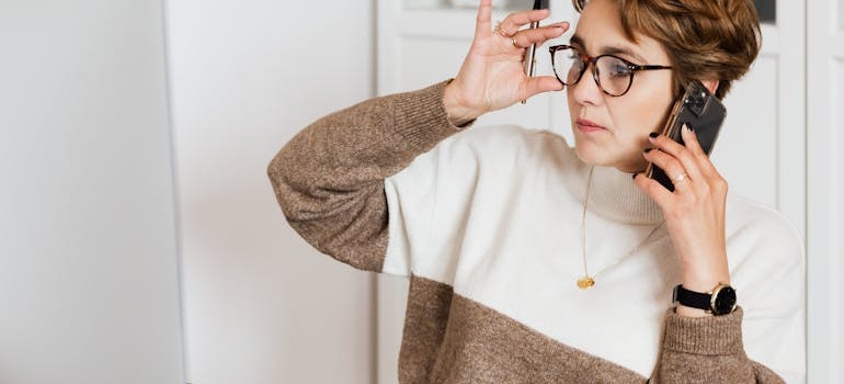 A woman trying to find the most affordable moving solutions in Ottawa over the phone while look at her laptop