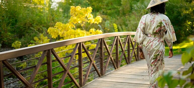 A woman crossing a wooden bridge