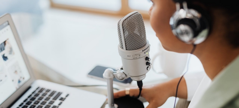 A woman is speaking over a microphone. 
