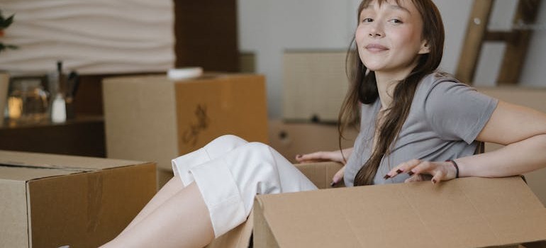 A young woman sitting inside a box