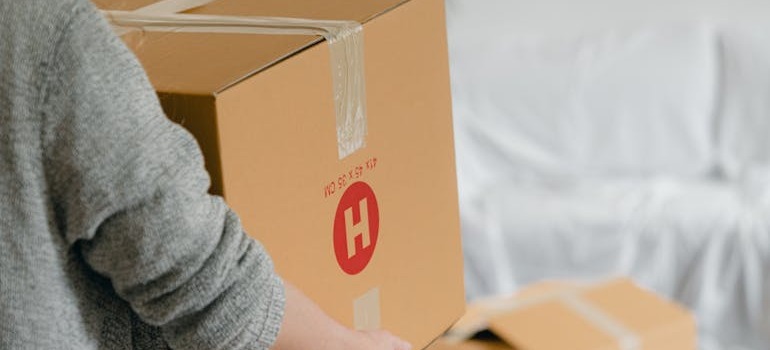 A person holding a moving box