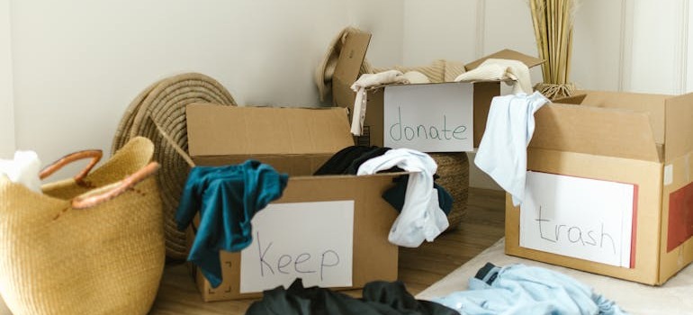 Keep, donate, throw away boxes in a room