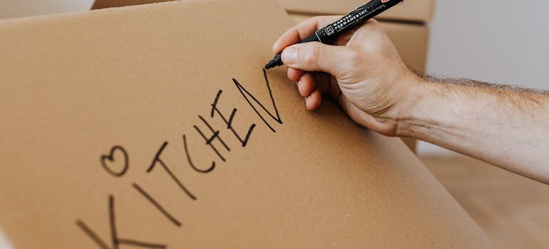 A person putting a lable on a box