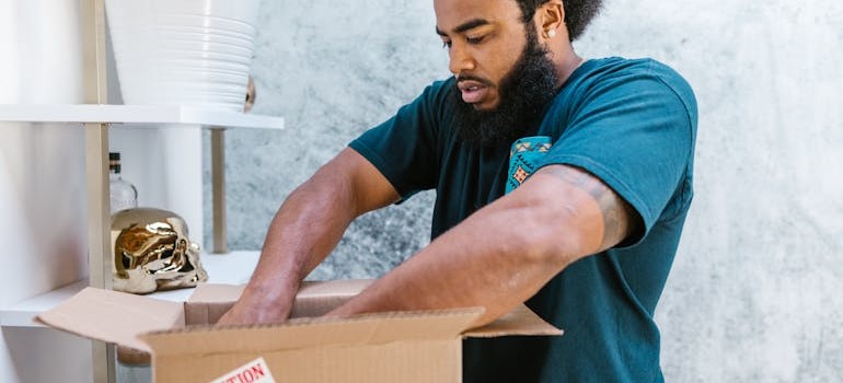 A mover packing items inside a box