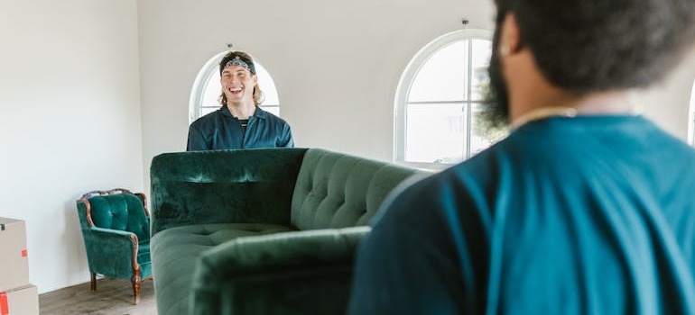 Two movers moving a sofa