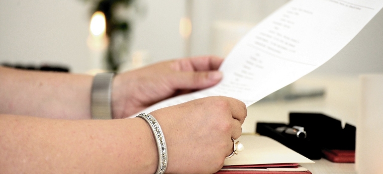 A person is holding and reading the contract. 