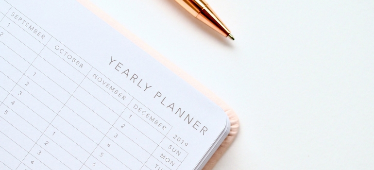 A pen and a planner on the desk will be used to find affordable movers Ottawa without sacrificing quality. 
