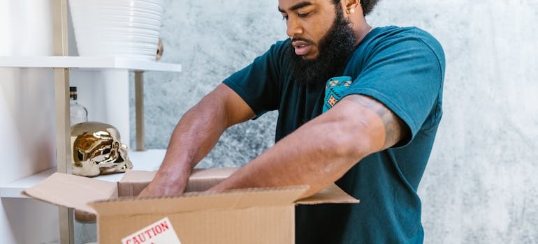A mover packing your boxes as hiring local Ottawa movers saves you time and stress