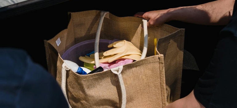 A woman is holding her bag after considering what to pack last on moving day in Ottawa. 