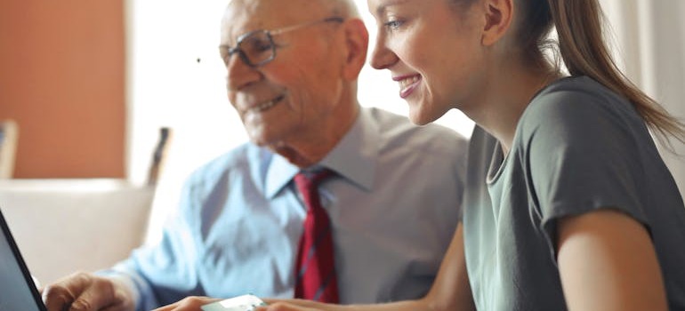 A granfather and granddaughter talking to each other about downsizing in retirement