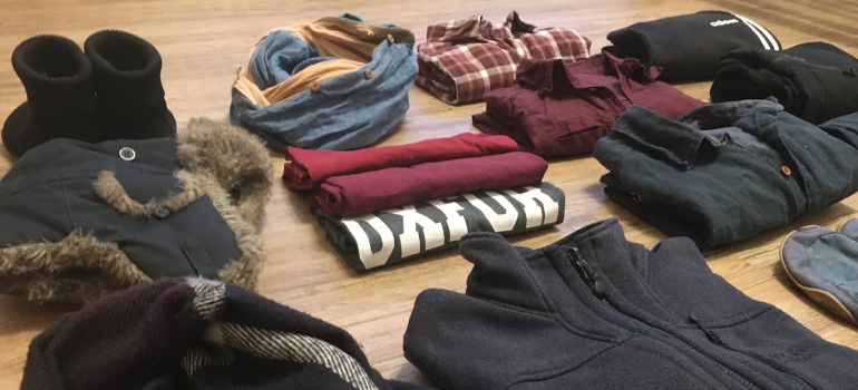 A pile of clothes folded on a table