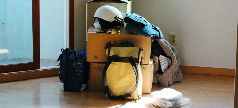 A pile of boxes, bags and a helmet ready to be stored at student summer storage in Ottawa