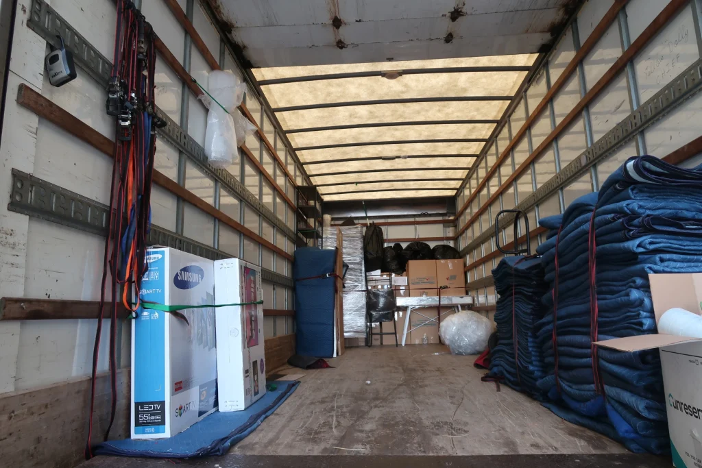 furniture and boxes organized inside a moving truck